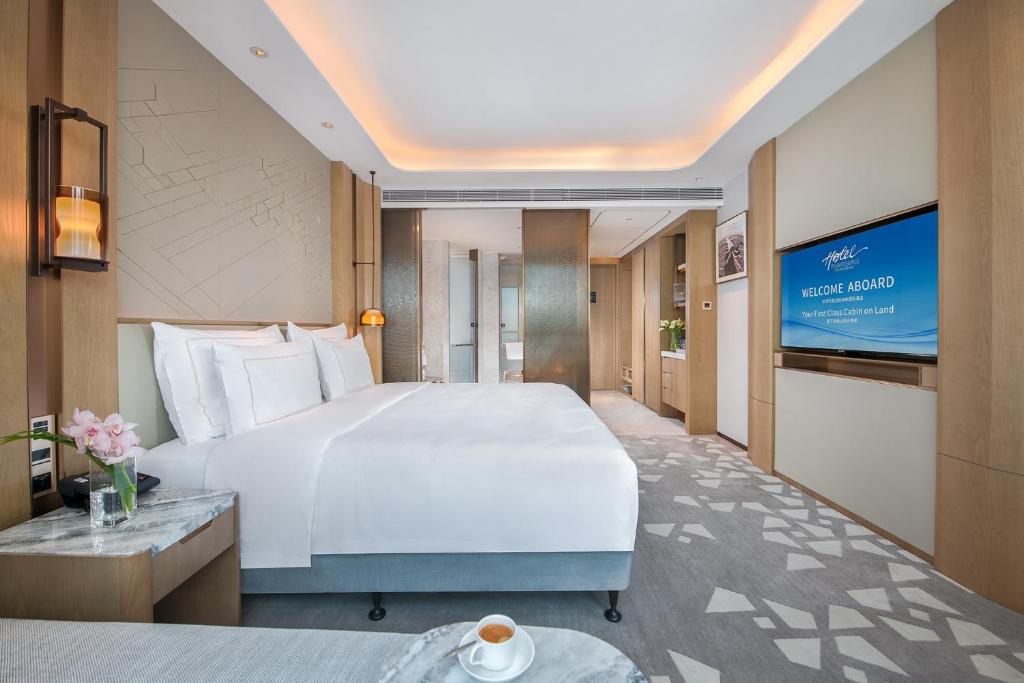 Postel nebo postele na pokoji v ubytování Shenzhenair International Hotel