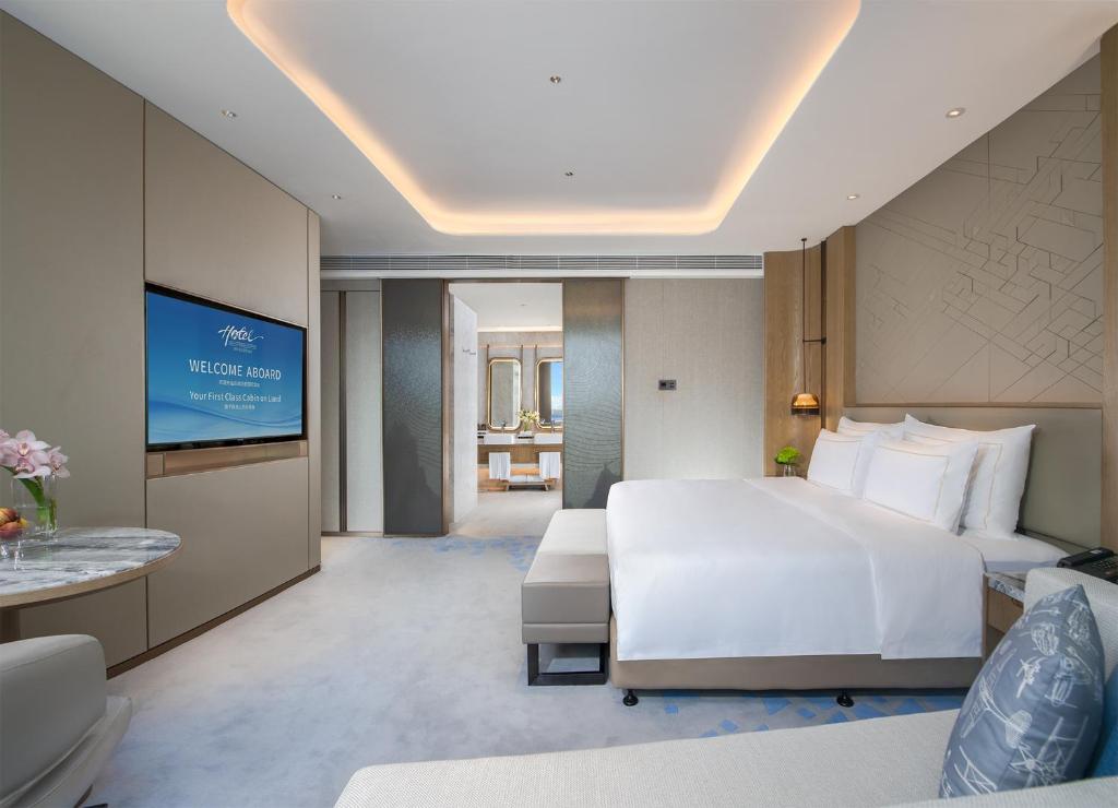 Postel nebo postele na pokoji v ubytování Shenzhenair International Hotel
