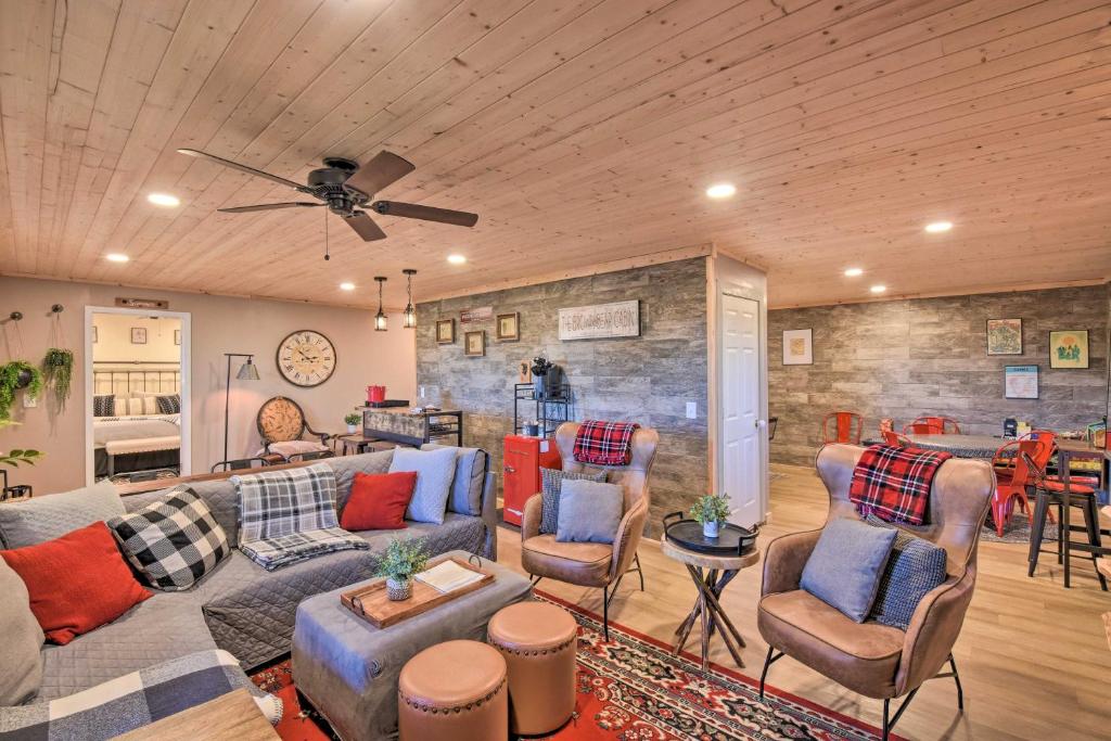 a living room with a couch and chairs at Lakemont Mtn Cabin with Game Room and Hot Tub! in Lakemont