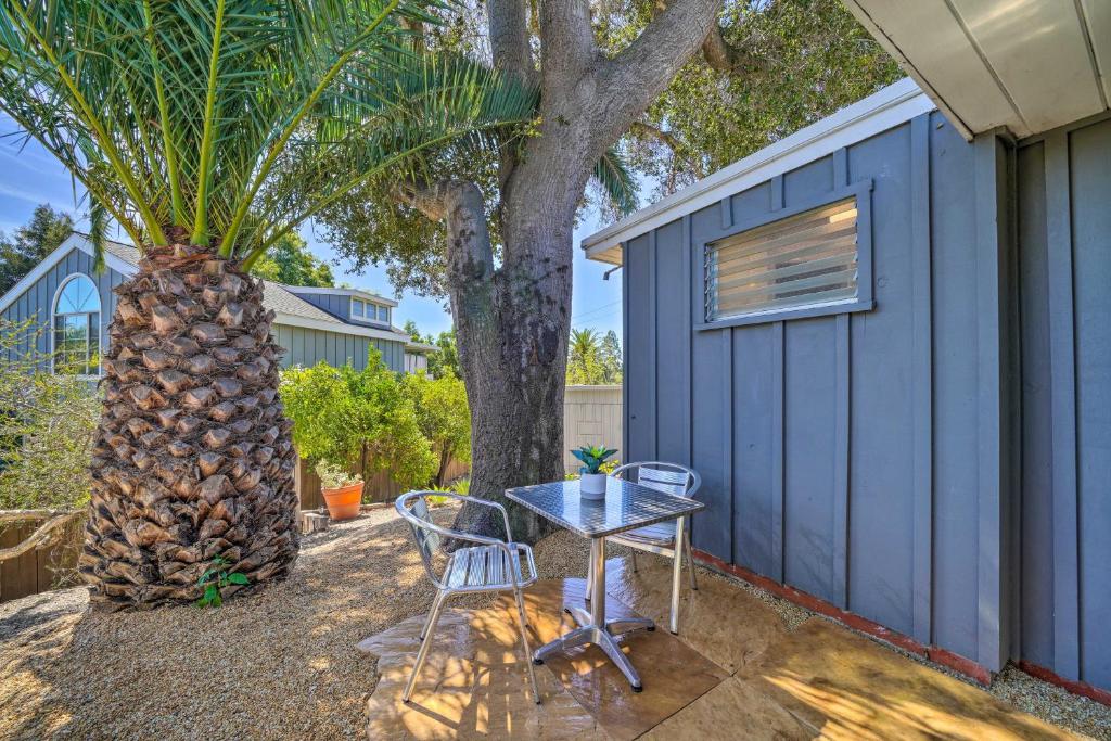 a table and chairs next to a blue building with a palm tree at Santa Barbara Studio Near Downtown and Beaches in Santa Barbara