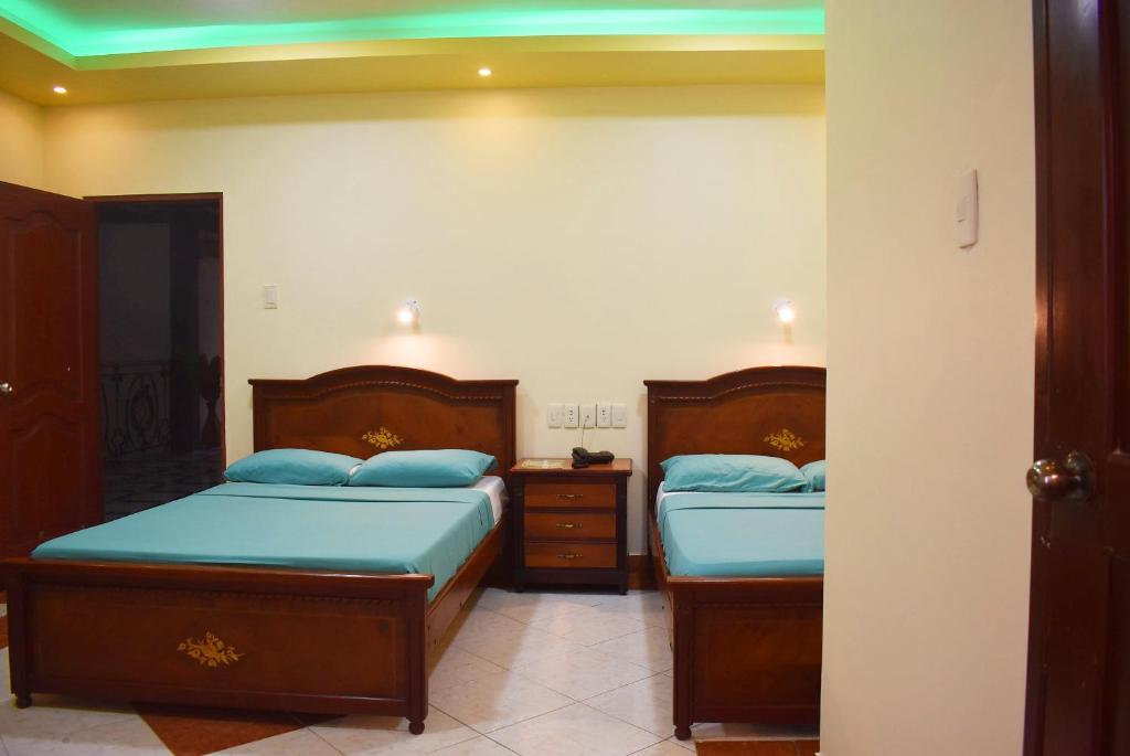 Postel nebo postele na pokoji v ubytování Hostal Galápagos - Guayaquil