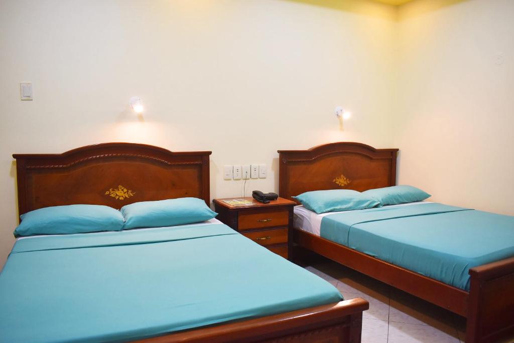 Postel nebo postele na pokoji v ubytování Hostal Galápagos - Guayaquil