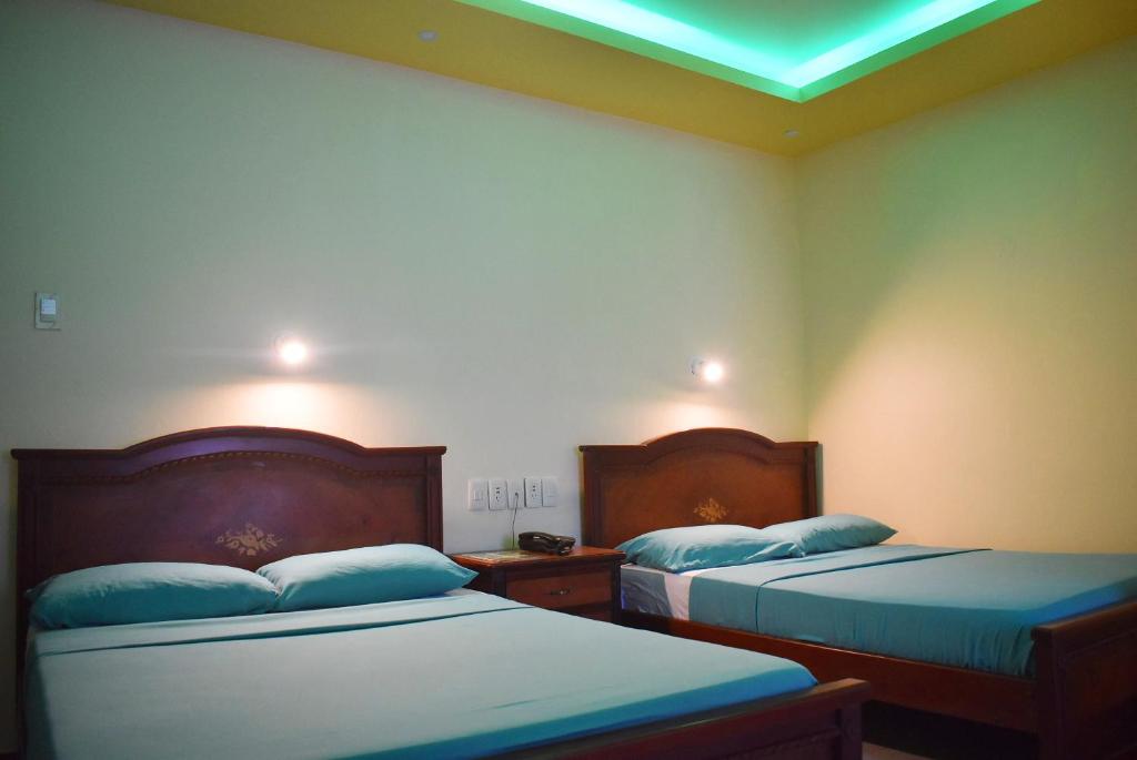 Postel nebo postele na pokoji v ubytování Hostal Galápagos - Guayaquil