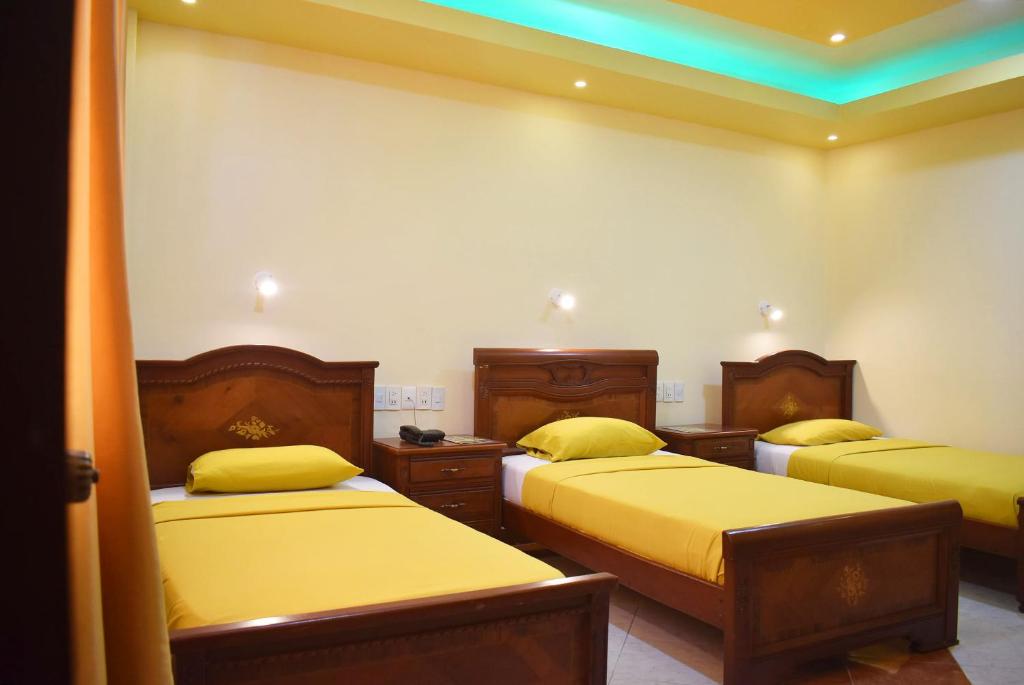 Postel nebo postele na pokoji v ubytování Hostal Galápagos - Guayaquil