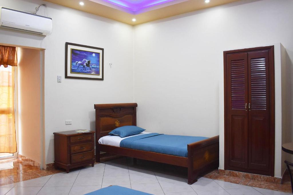 Postel nebo postele na pokoji v ubytování Hostal Galápagos - Guayaquil