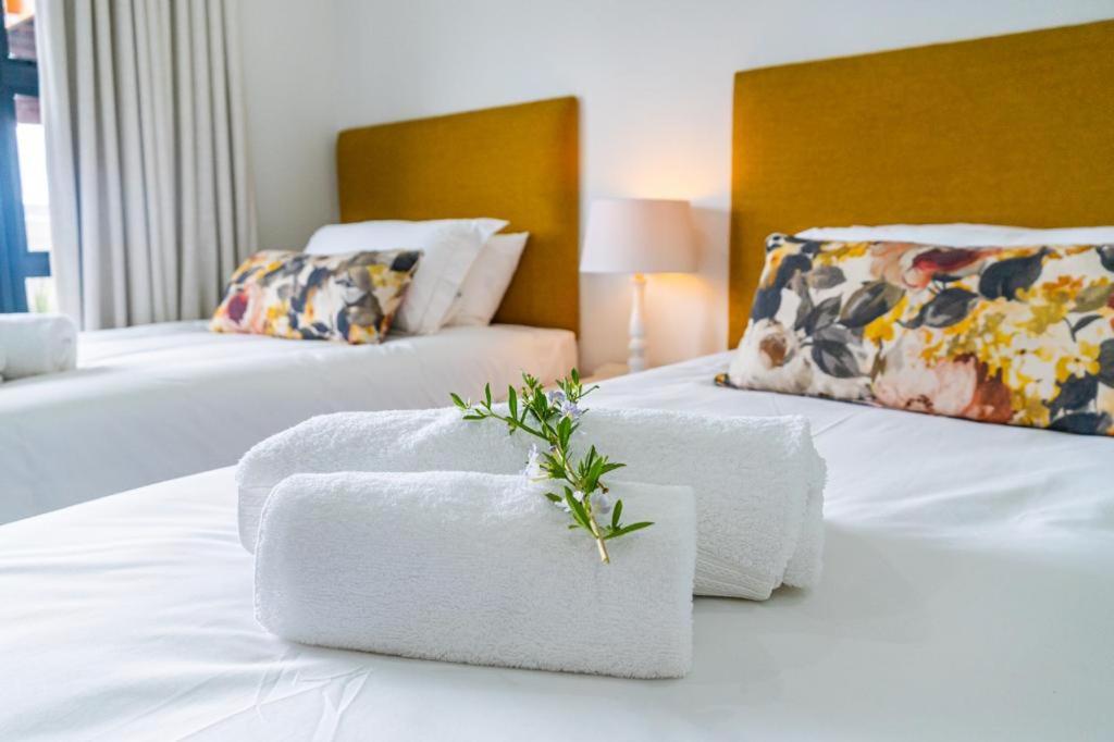 a hotel room with two beds with towels on them at Verdant Hills in Reebok