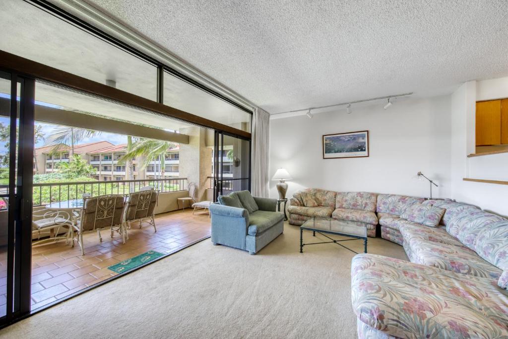 a living room with a couch and a table at Kaanapali Royal F303 in Lahaina