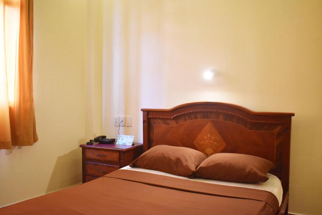 Postel nebo postele na pokoji v ubytování Hostal Galápagos - Guayaquil