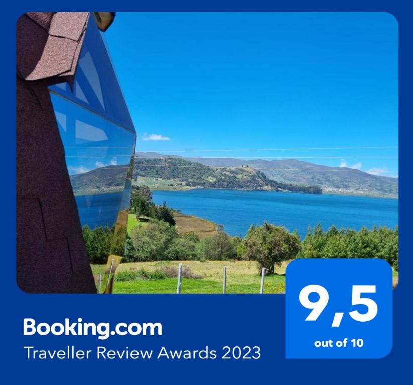 a sign that says travel review awards with a picture of a lake at Domos Lago Muisca Chia in Aquitania