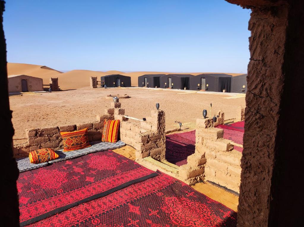 a view from a window of a building in the desert at Bivouac Le charme d'Aladdin in El Gouera