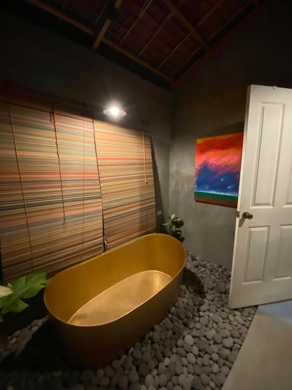 a bathroom with a large tub and a window at La Luna Elyu 