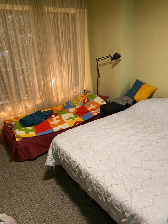a bedroom with a bed with a colorful blanket at Bakuriani Kokhta Mitarbi Resort in Bakuriani