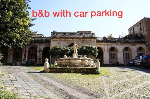 a fountain in front of a building with the words bed with car parking at Chebedda B&B in Catania