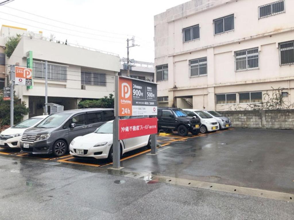 a parking lot with cars parked in front of a building at Mcity in Maejima - Vacation STAY 54897v in Naha