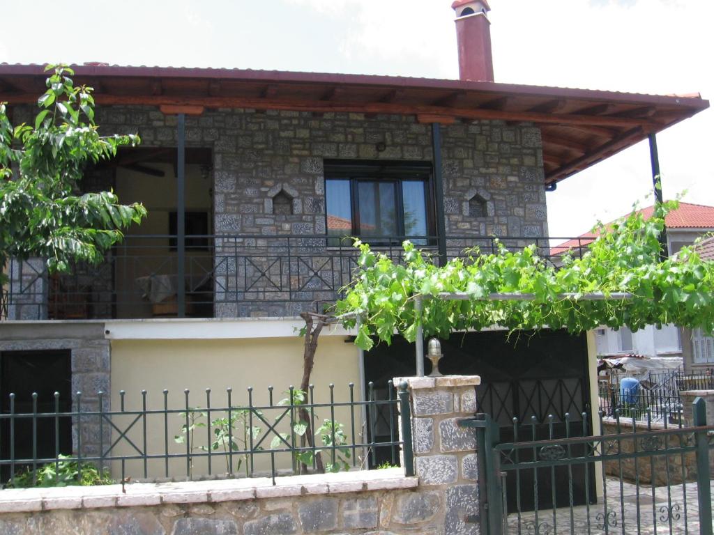 uma casa com uma cerca em frente em Καταφύγιο em Vytina