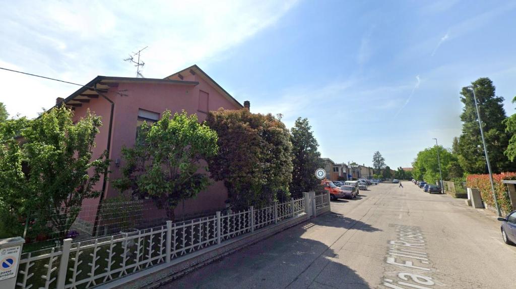 a pink building on the side of a street at Affittacamere da Alina in Argelato