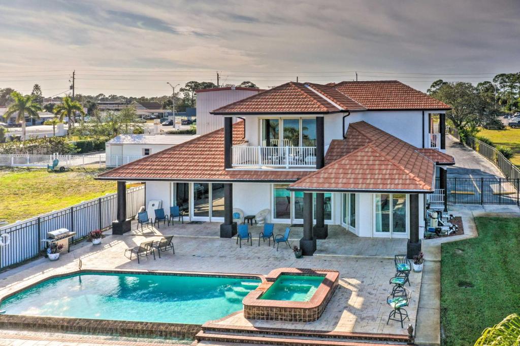 an aerial view of a house with a swimming pool at Riverfront Titusville Home with Pool and Pickleball! in Titusville
