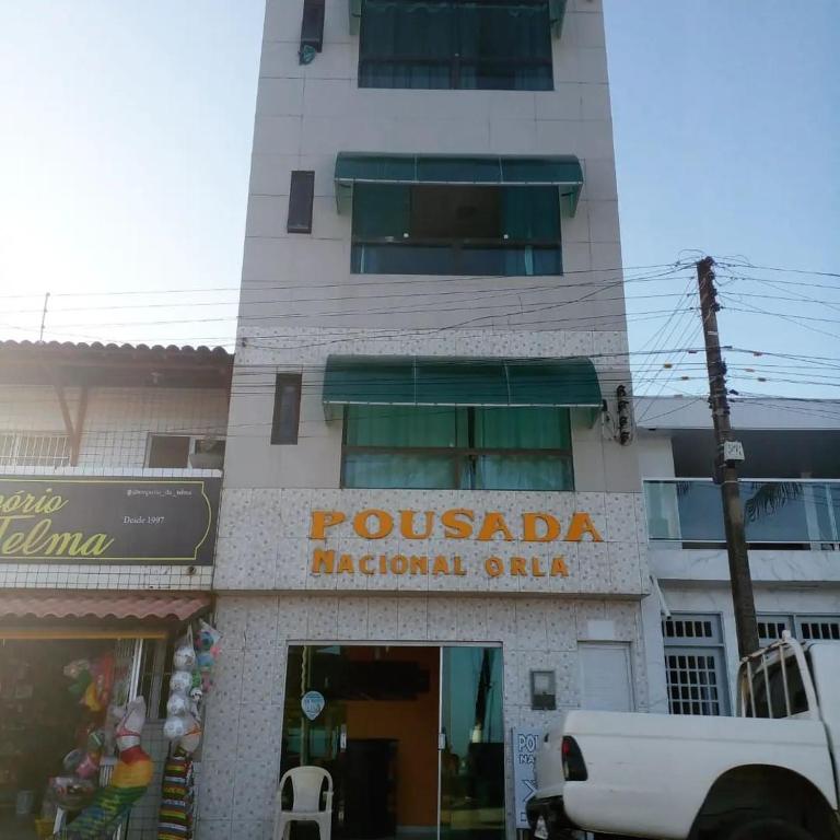 un edificio con un cartel que lee la oficina nacional de Puchada en Pousada Nacional Orla, en Maragogi