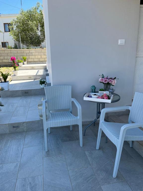 a patio with two chairs and a table at Villa Angelina Ksamil in Ksamil