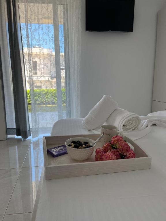 a tray with two bowls of fruit on a table at Villa Angelina Ksamil in Ksamil