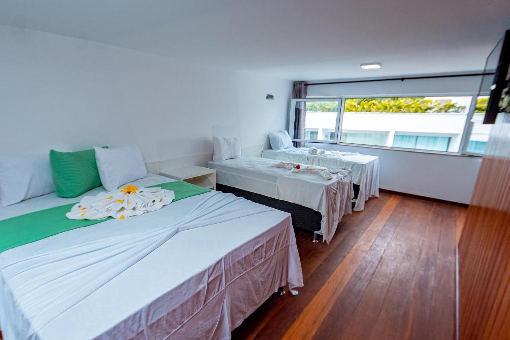 Postel nebo postele na pokoji v ubytování Brisa do Mar Praia Hotel