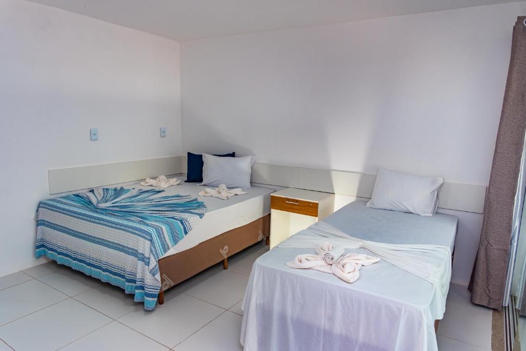 Postel nebo postele na pokoji v ubytování Brisa do Mar Praia Hotel