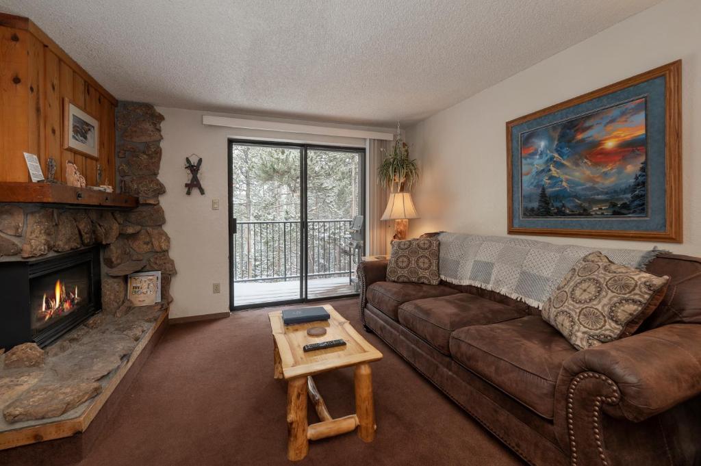 a living room with a couch and a fireplace at Beaver Village Unit #0621 in Winter Park