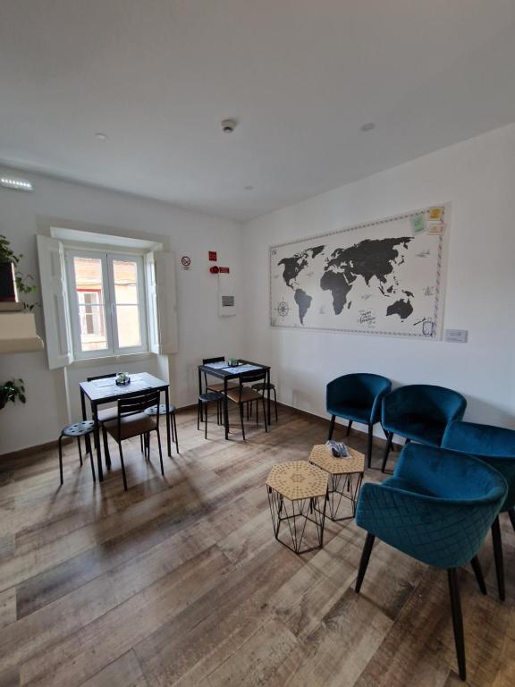 a waiting room with chairs and tables and a map on the wall at Casa do Albuquerque in Sintra