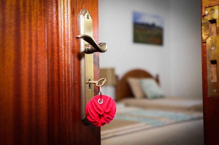 a red towel is hanging from a door at Casa Fundo de Vila in Manteigas