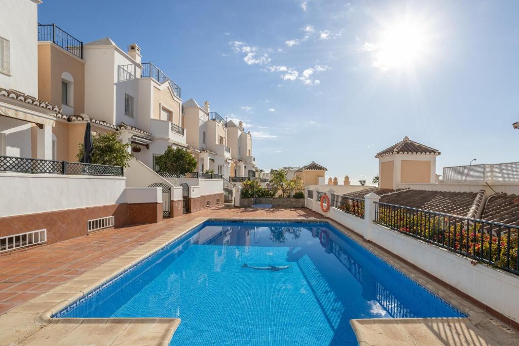 a swimming pool in the backyard of a house at Casa Chloe in Nerja