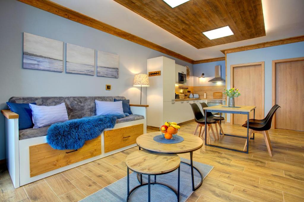 a living room with a couch and a table at Rezidence KUPEC in Frymburk
