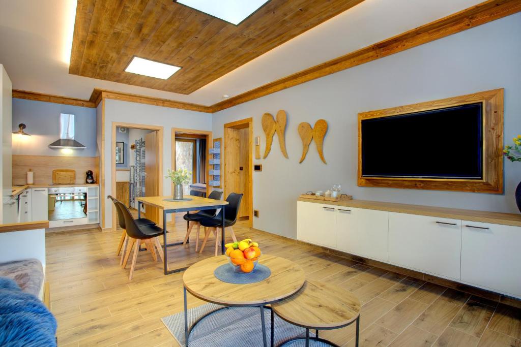 a living room with a flat screen tv on the wall at Rezidence KUPEC in Frymburk