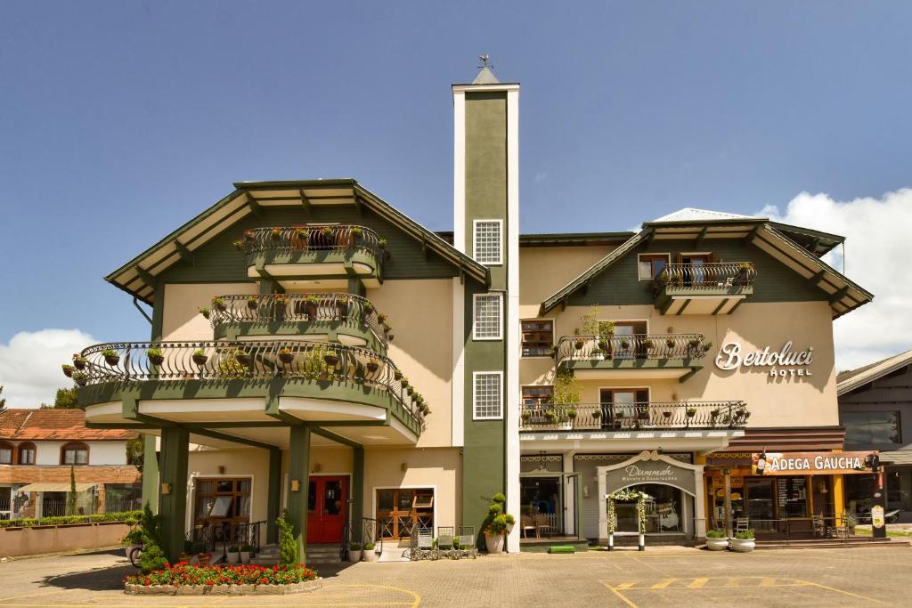 a large building with balconies on the side of it at Hotel Bertoluci in Gramado