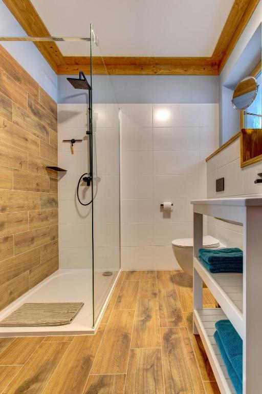 a bathroom with a shower and a glass shower stall at Rezidence KUPEC in Frymburk
