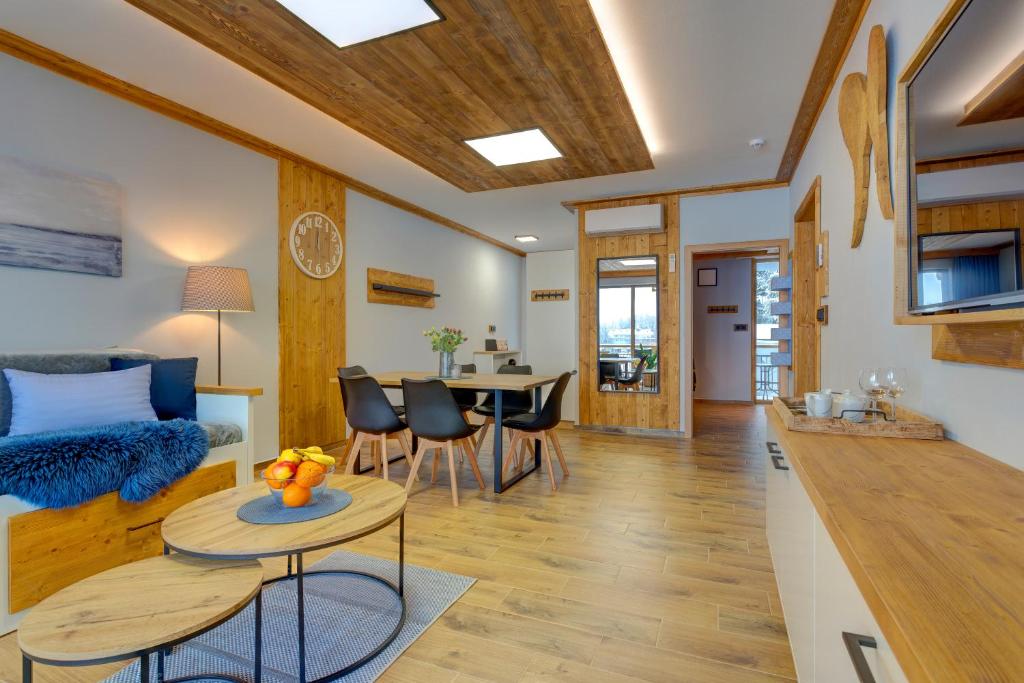 a living room with a couch and a table at Rezidence KUPEC in Frymburk