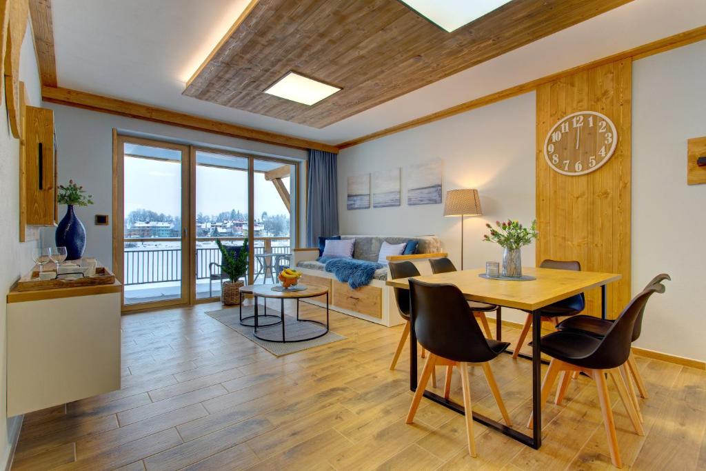 a living room with a table and chairs and a couch at Rezidence KUPEC in Frymburk