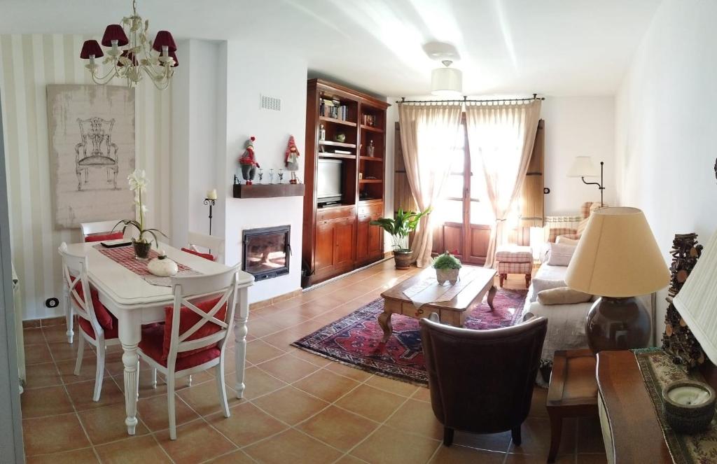 a living room with a table and a couch at OROEL Beds & Dreams - Espectacular planta baja en Badaguás-Pirineo in Badaguás