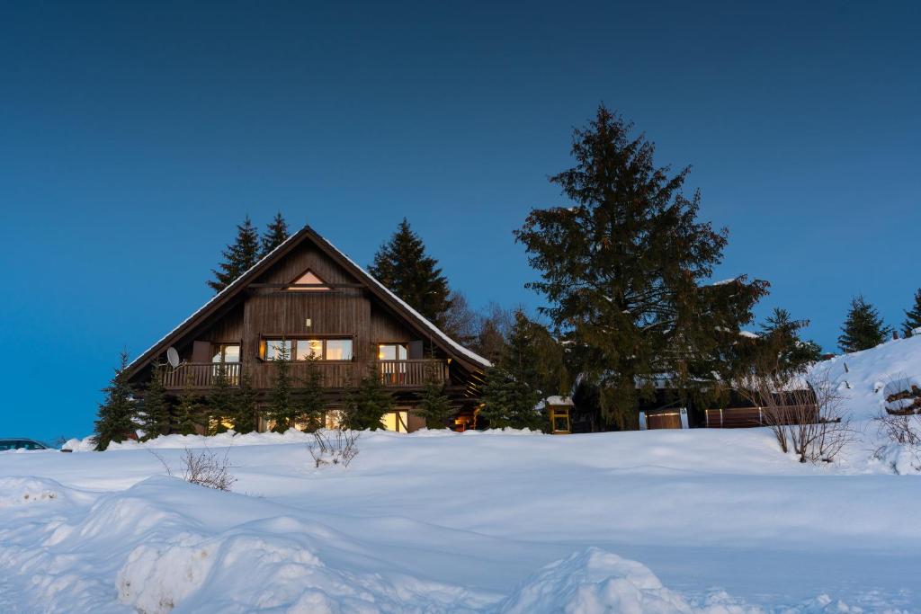 a large wooden house in the snow with snow at Zrub Krahule in Krahule