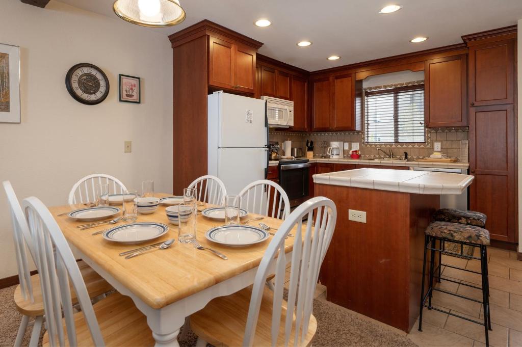 a kitchen with a wooden table and chairs in a kitchen at Hi Country Haus Unit 1913 in Winter Park