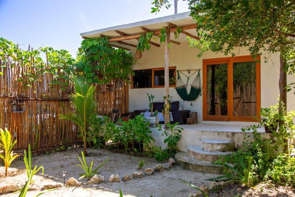 a home with a fence and a patio at Casa Lunada in Holbox Island