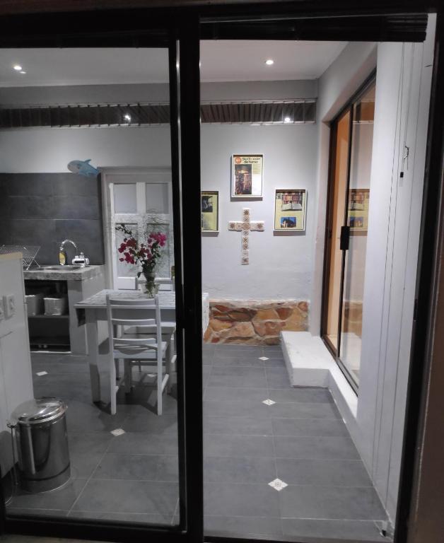 a view of a kitchen from a glass door at La Chapelle - The Apartment in Montagu