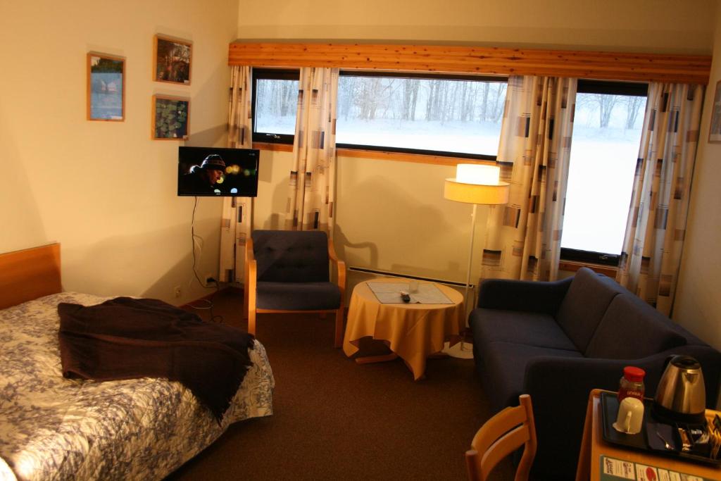 Postel nebo postele na pokoji v ubytování Overhalla Hotel