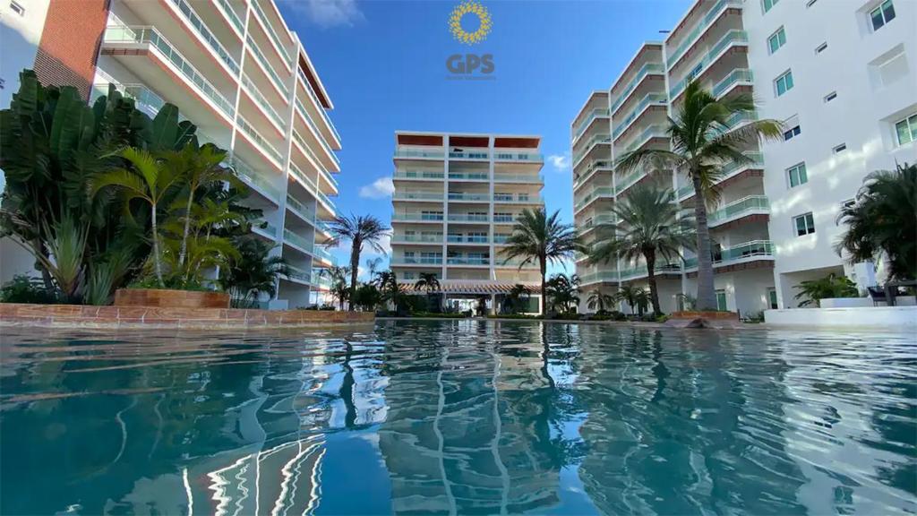 a swimming pool in front of two buildings at 3010 Habitación en Pacifika, excelente ubicación in Mazatlán