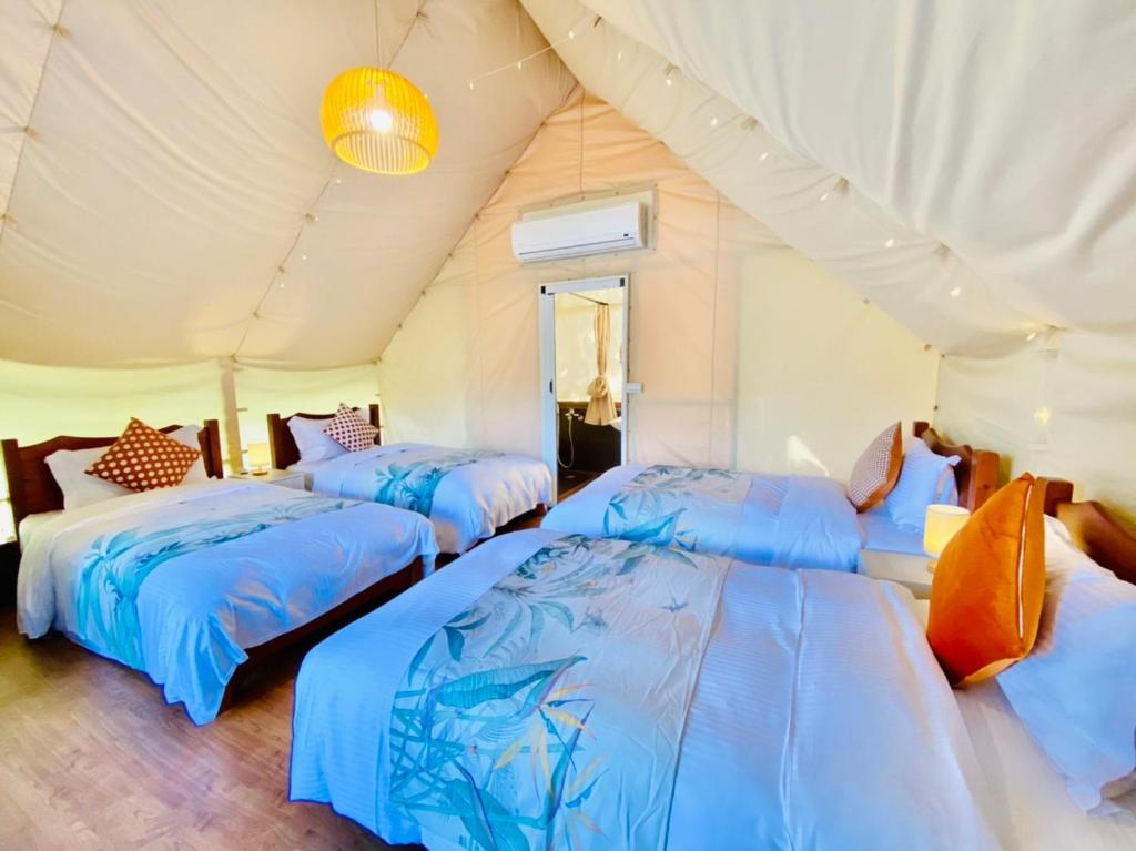 a room with three beds in a tent at 見晴花園山莊Sunshine Villa in Ren&#39;ai