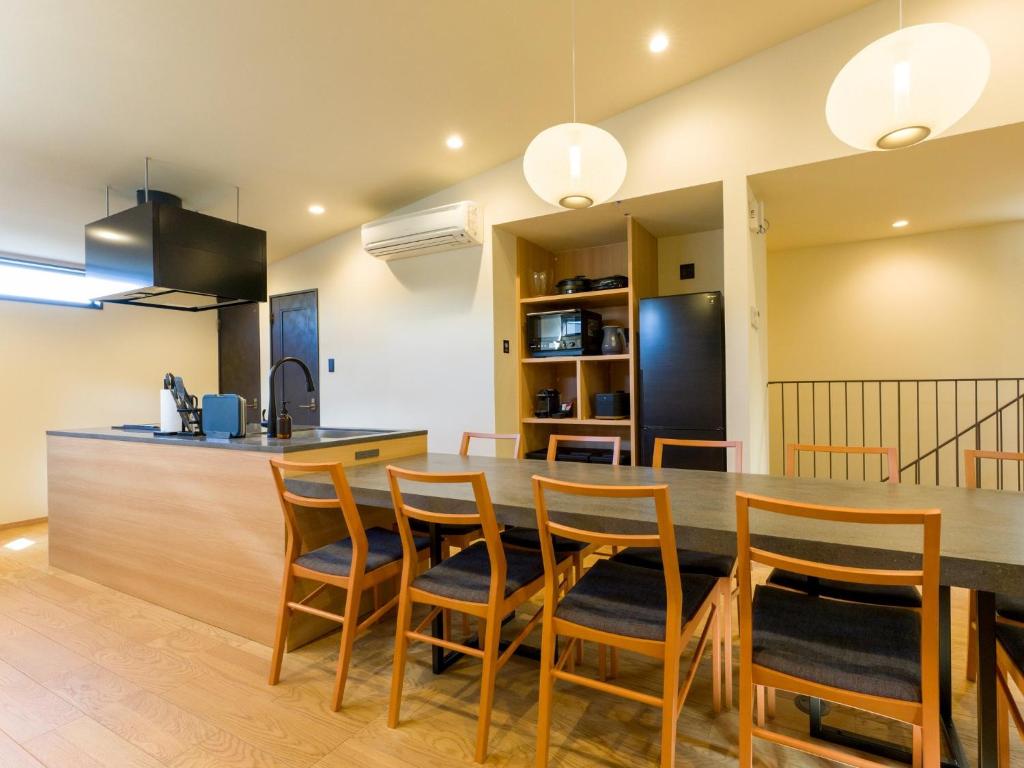 a kitchen and dining room with a table and chairs at Rakuten STAY VILLA Kamogawa Building B with Terrace and sauna Capacity of 12 persons in Kamogawa