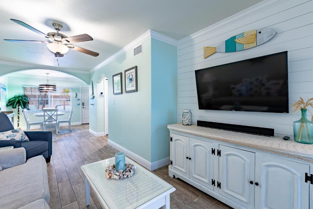 a living room with a large flat screen tv at Gorgeous Coastal Condo Barefoot Beach Indian Shore in Clearwater Beach