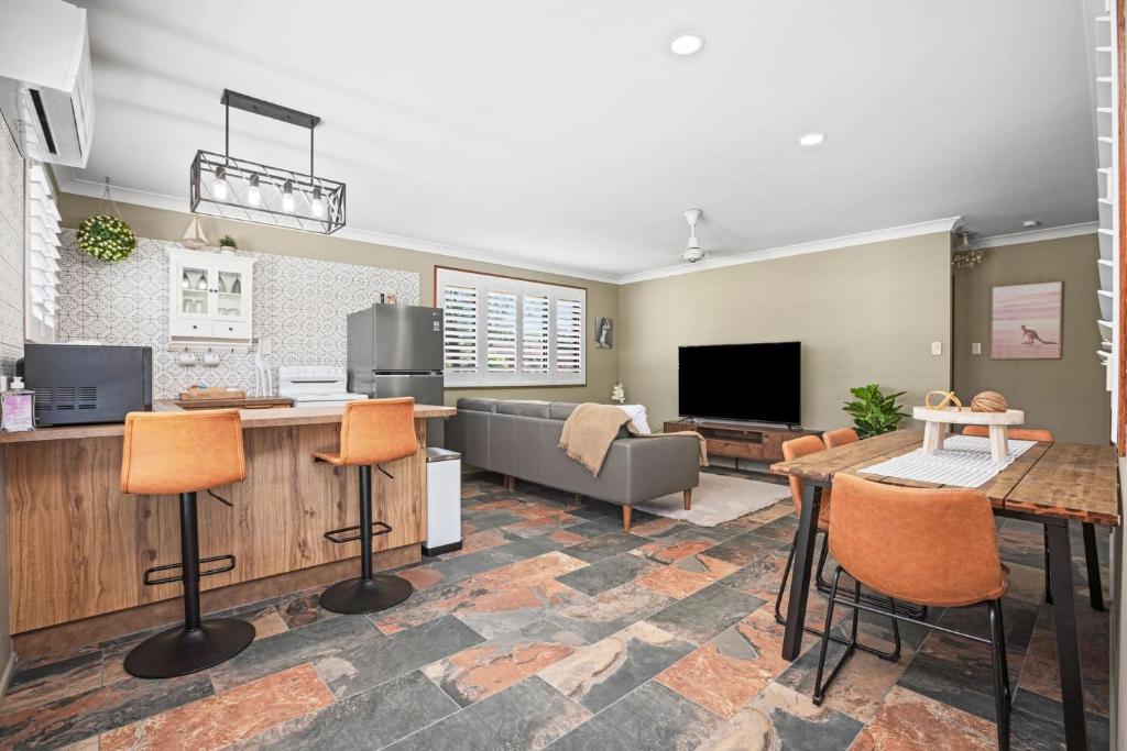 a living room with a couch and a table at Akuli By The Sea Unit 4 in Iluka