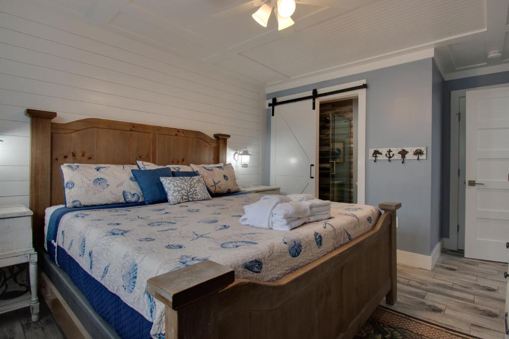 a bedroom with a bed with a wooden head board at Seas the Day - Boardwalk to the Beach, 3 pools, Tennis in Hilton Head Island