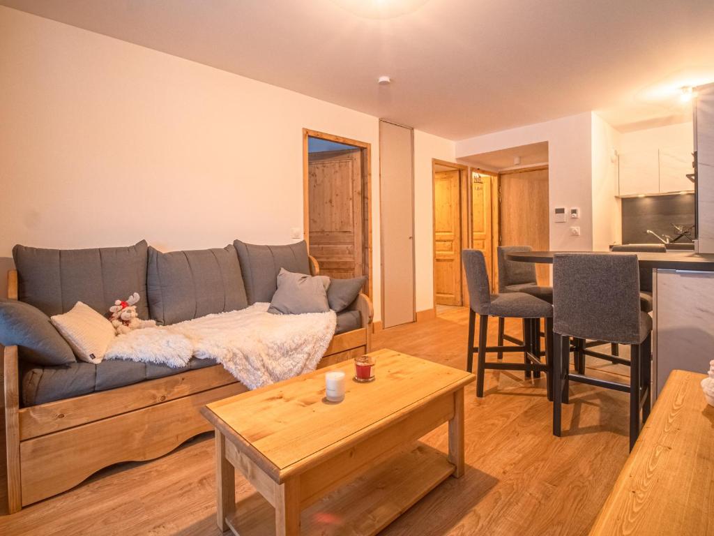 a living room with a couch and a table at Appartement Valmorel, 2 pièces, 4 personnes - FR-1-356-412 in Valmorel