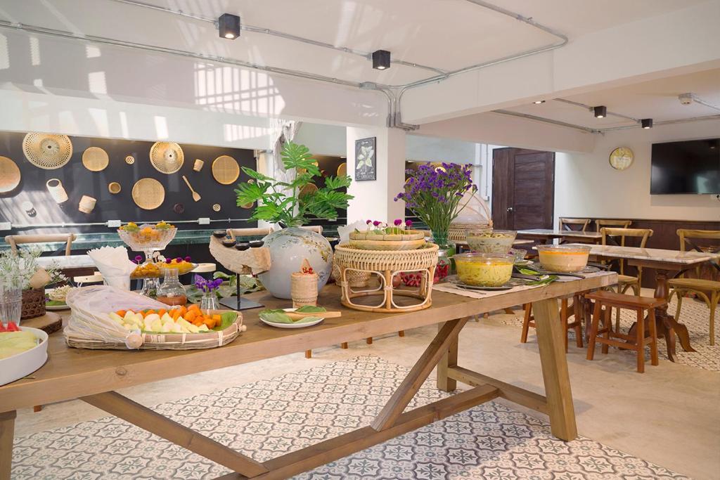 A buffet breakfast spread set across long wooden tables in a bright dining room.